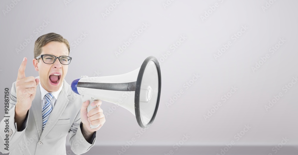 Composite image of geeky businessman shouting through megaphone