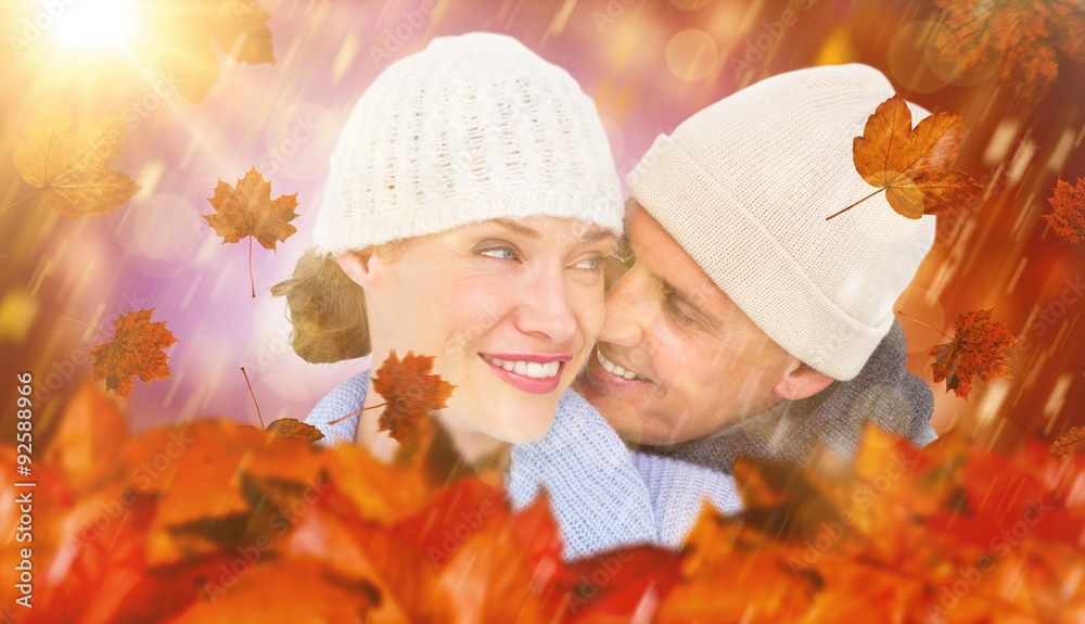 Composite image of casual couple in warm clothing