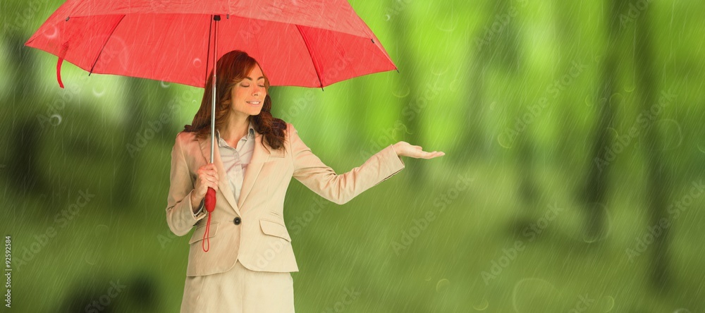 迷人的女商人撑着红色雨伞的合成图像