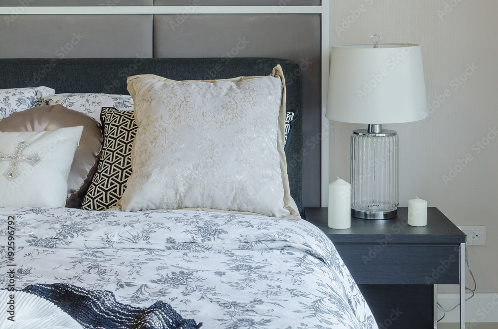 luxury bedroom with glass lamp on dark brown wooden table