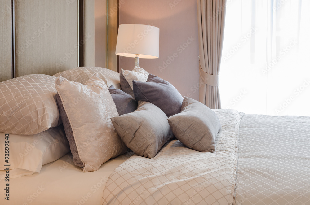 luxury bedroom with pillows on bed and white classic lamp