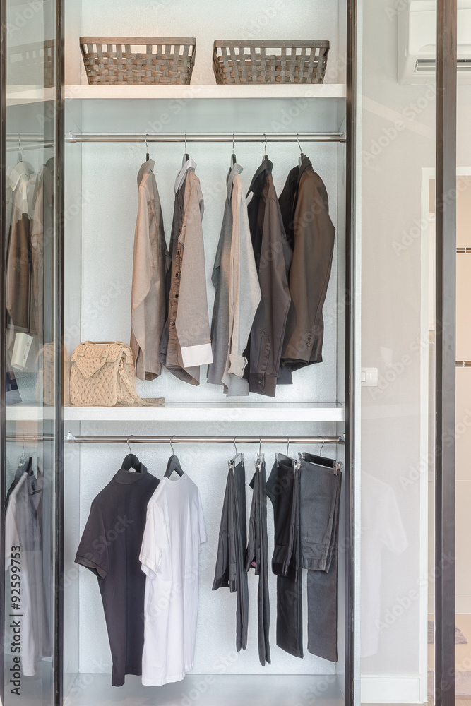 clothes hanging on rail  in white wardrobe