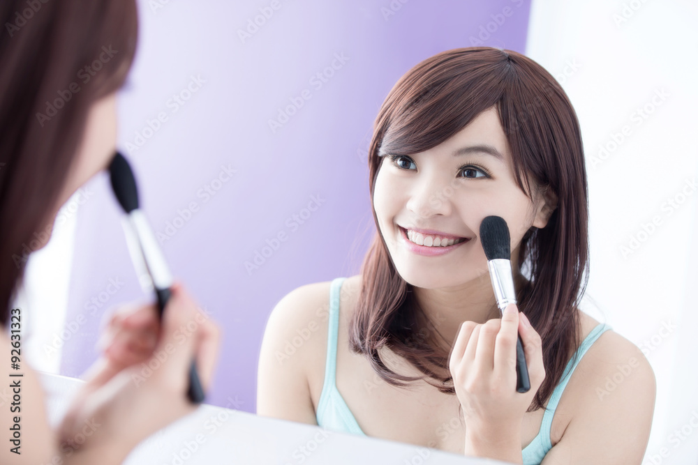 Smile woman with makeup brushes