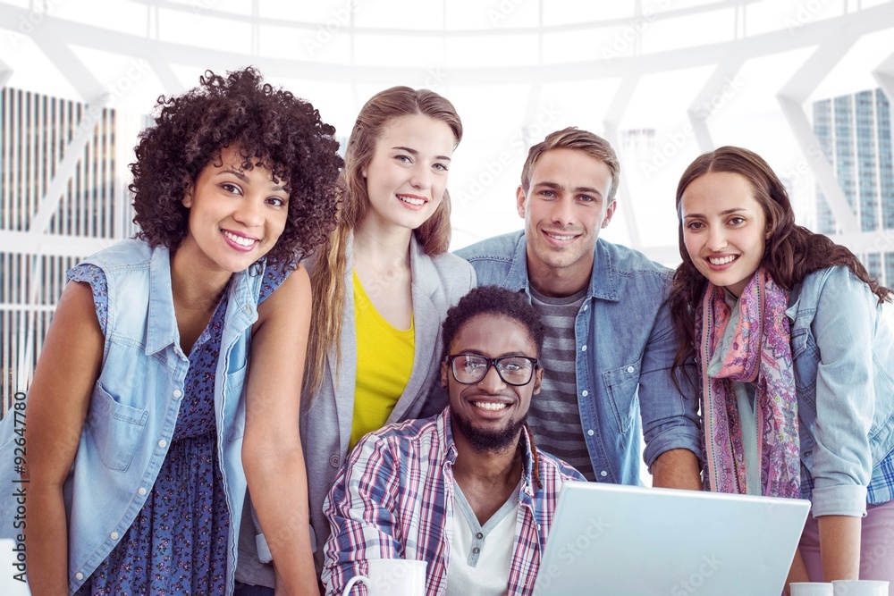 Composite image of fashion students working as a team 