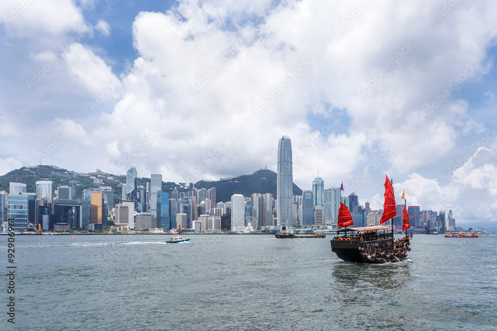 fishing-boat in the water with skyscrapers