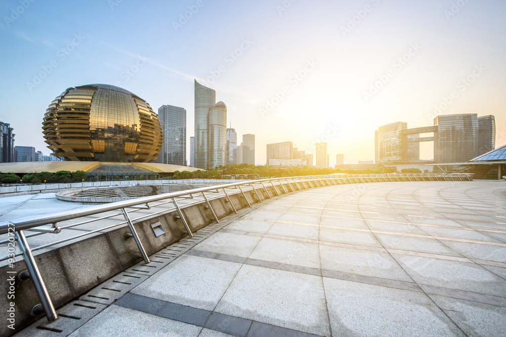 modern square and skyscrapers under sunbeam