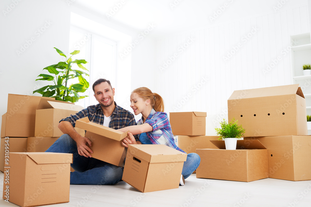 moving to a new apartment. Happy family couple and cardboard box