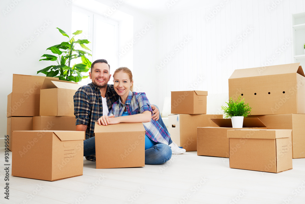 moving to a new apartment. Happy family couple and cardboard box