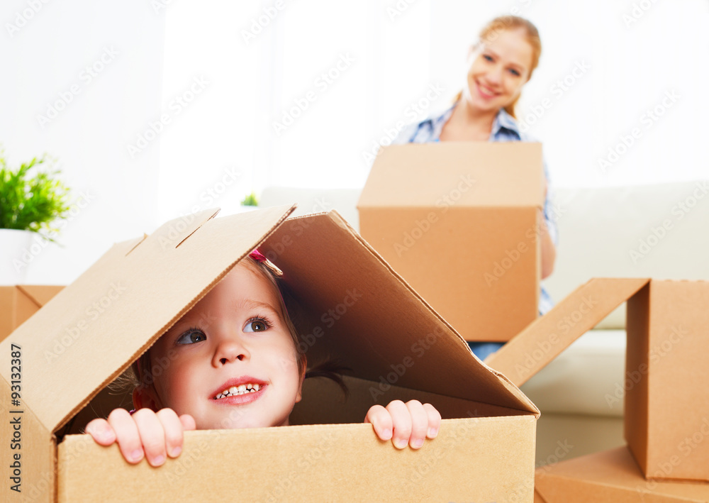 happy family moves into a new apartment. happy baby in a cardboa