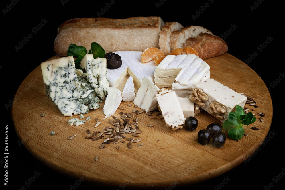 Cheese plate served with olive, nuts and bread