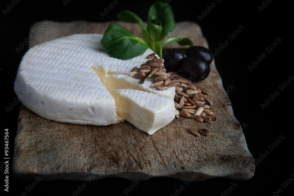 Camambert cheese with olives