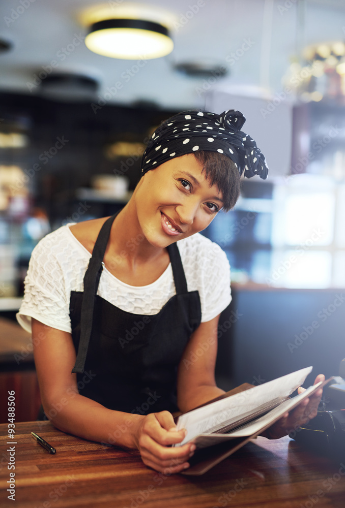 Smiling young coffee house owner