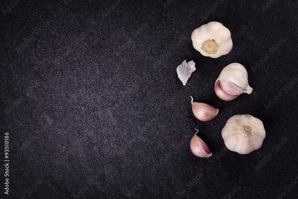  a still life arrangement of Three whole garlic bulbs grouped 