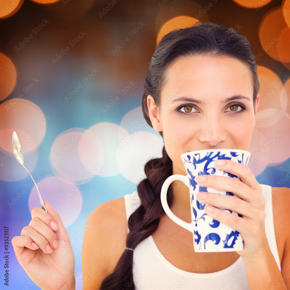 Composite image of pretty brunette having cup of tea