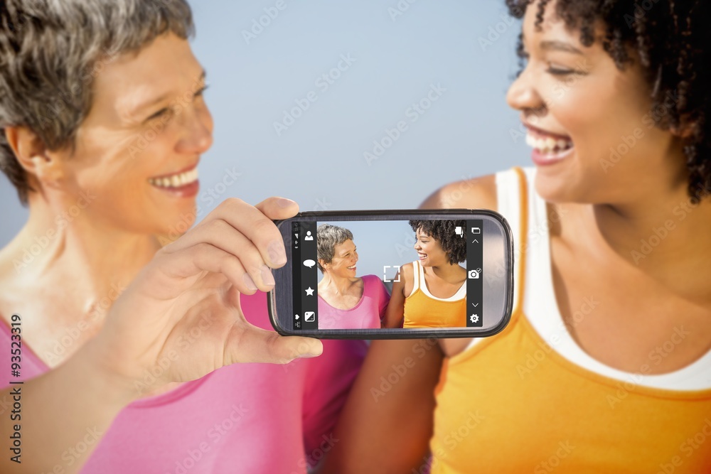 Composite image of hand holding smartphone showing