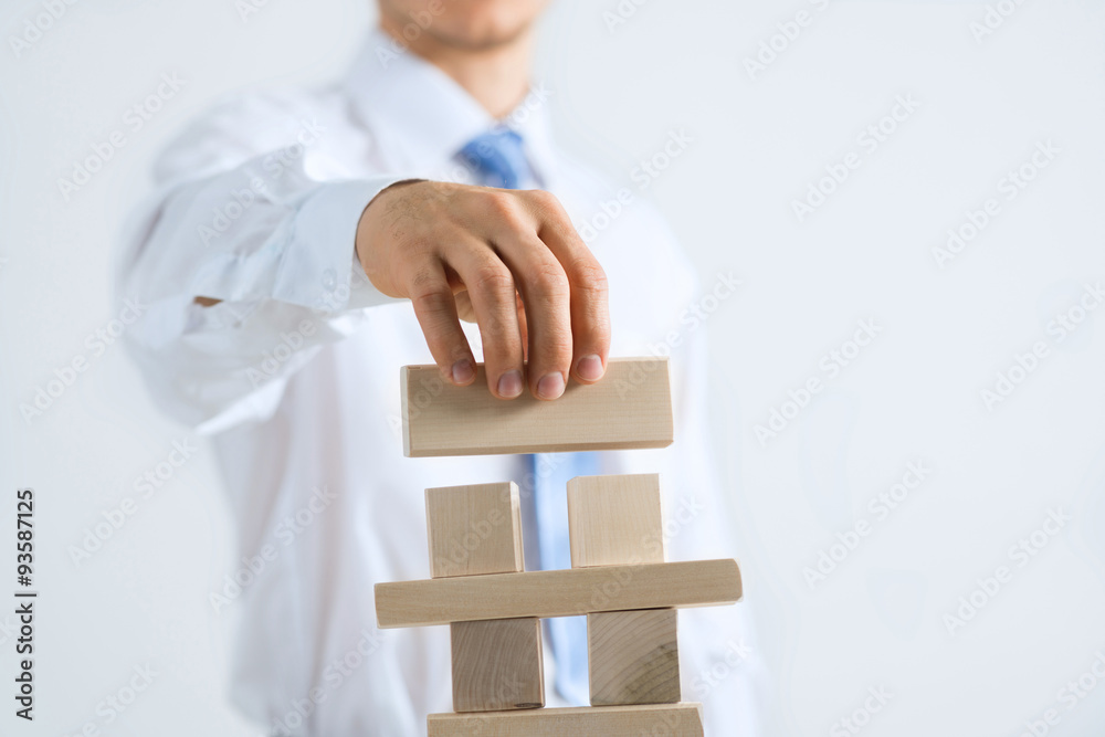 Businessman making tower