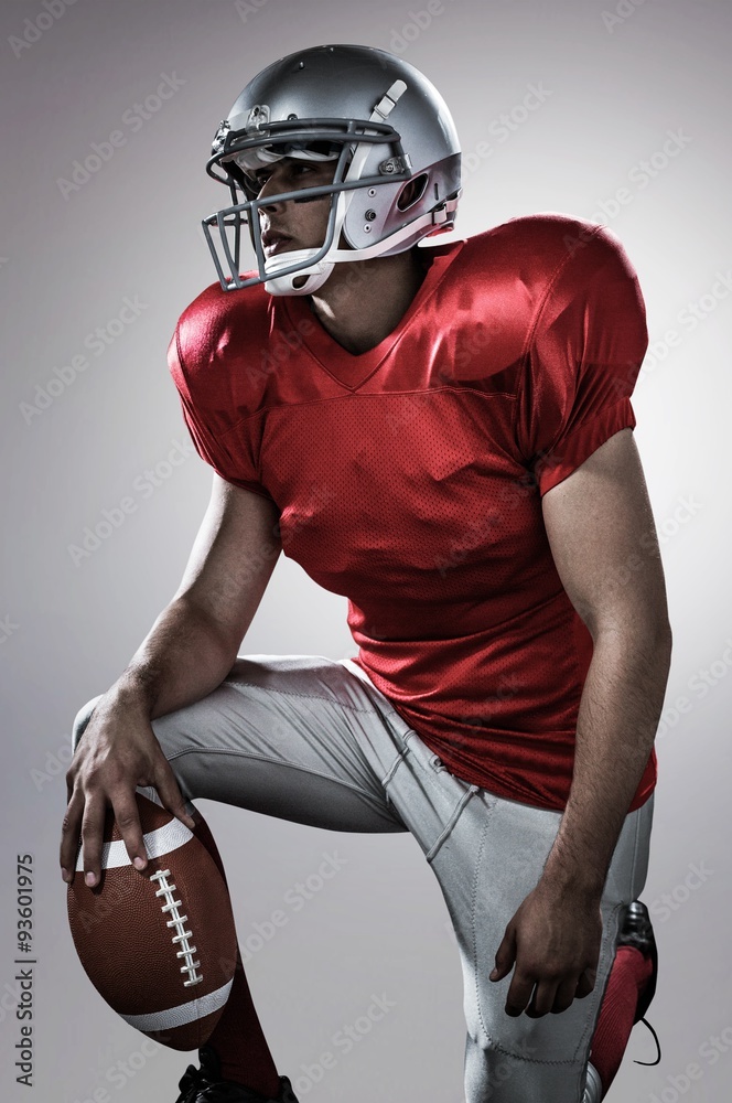 American football player holding ball