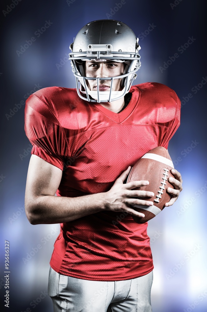 Composite image of  american football player holding ball