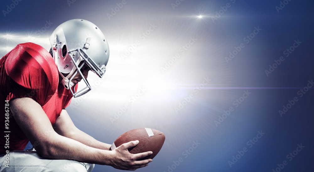 Composite image of american football player crouching with ball