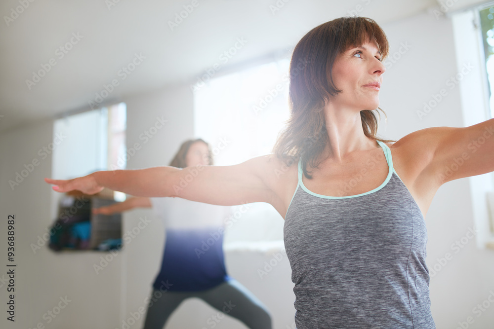  Women exercising at yoga class.