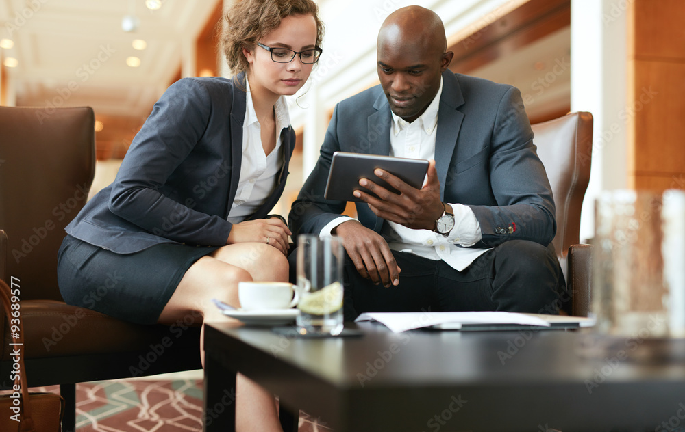 Businesspeople looking at digital tablet