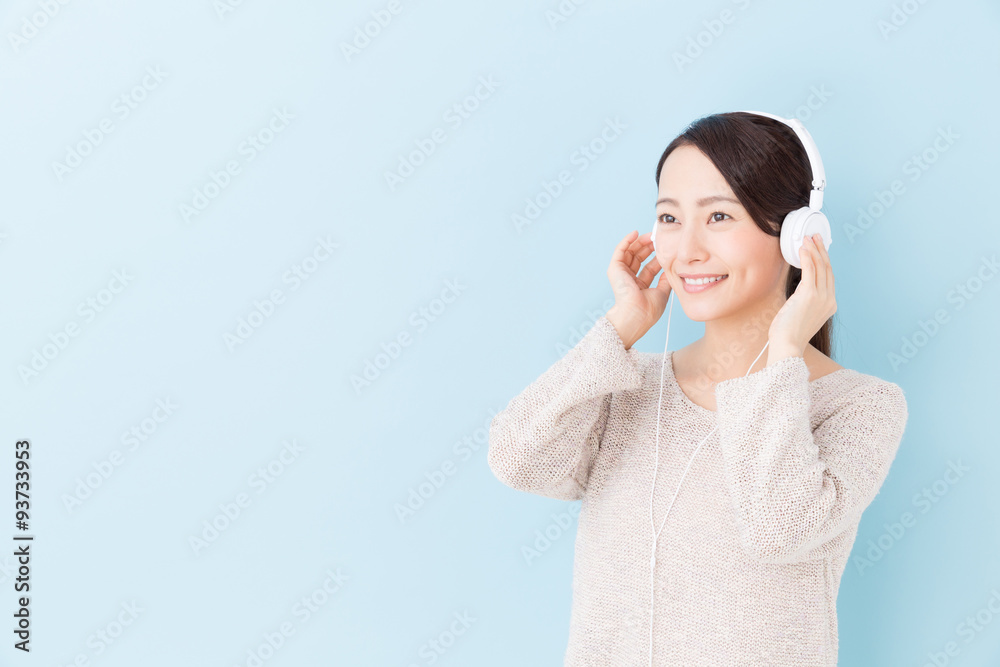 young asian woman listening to music