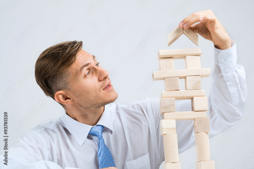 Businessman making tower