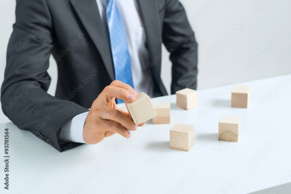 Businessman making tower