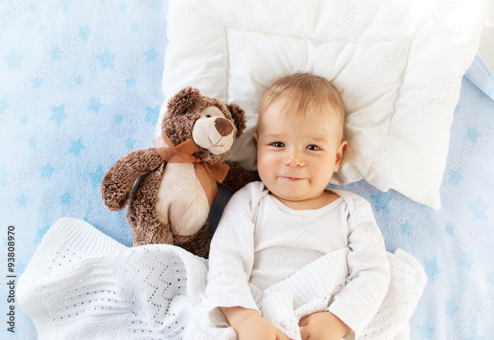 One year old baby with a teddy bear