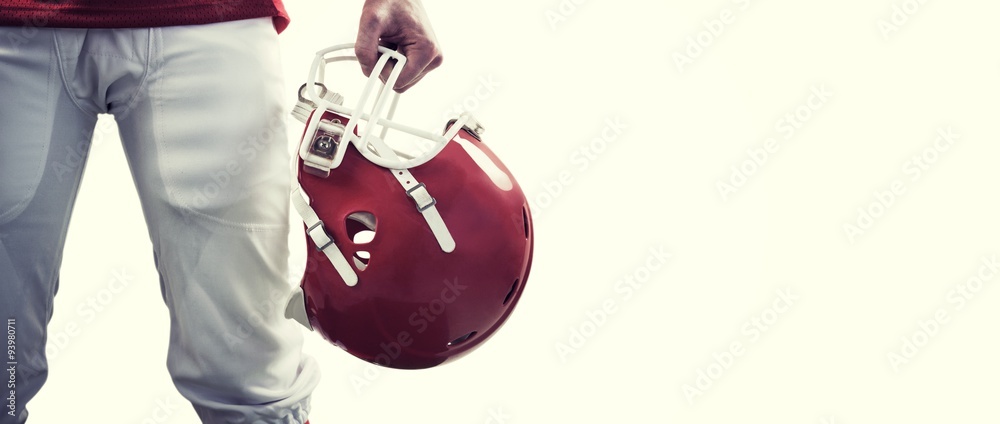 Composite image of an american football player taking his helmet