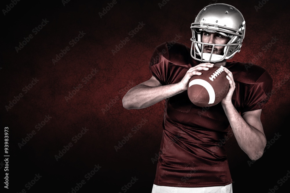 Composite image of american football player holding ball