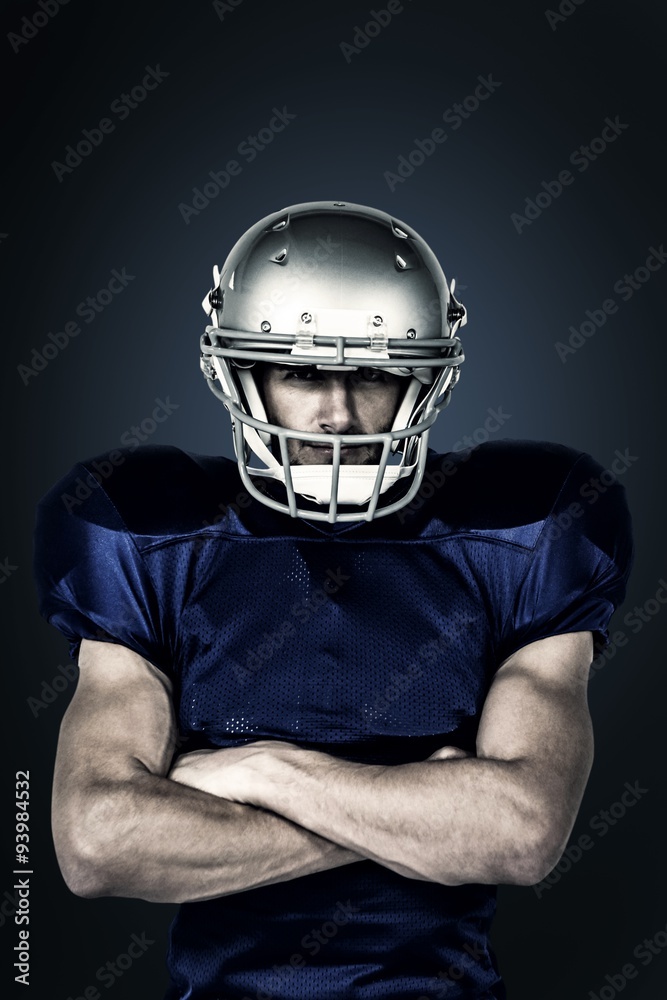 Composite image of american football player with arms crossed