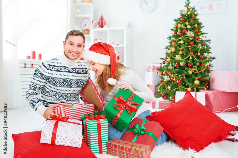 happy  family couple with a gift on Christmas at home