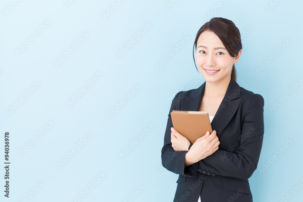 portrait of asian businesswoman on blue background