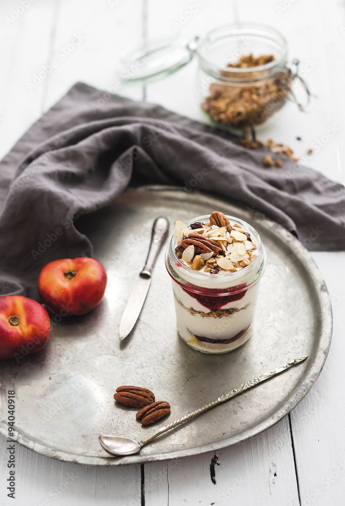 Yogurt oat granola with berries, honey, nuts and nectarins in