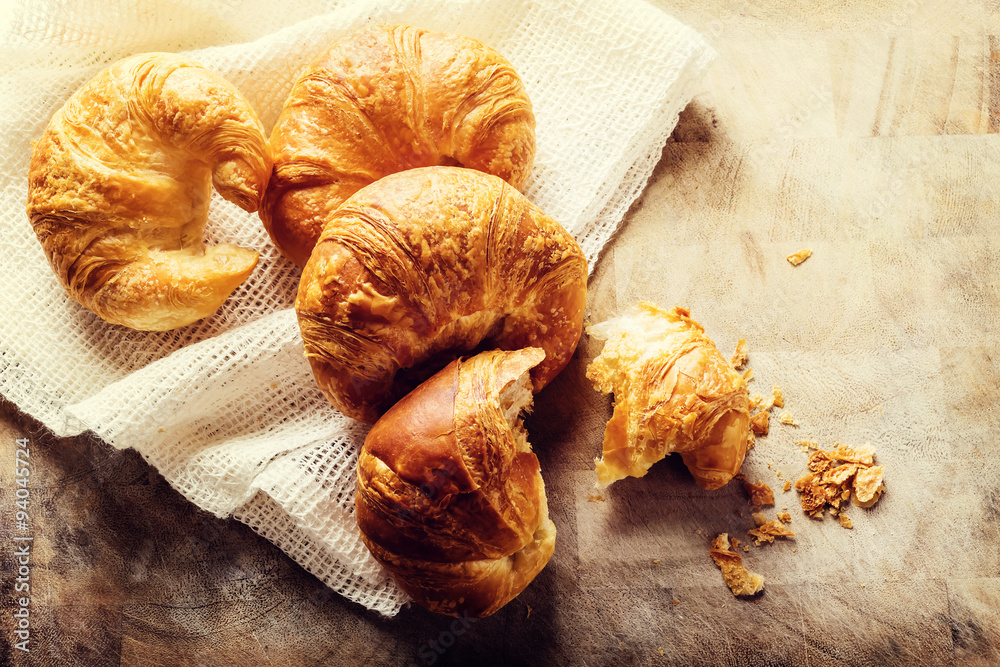 Batch of croissants on a rustic table