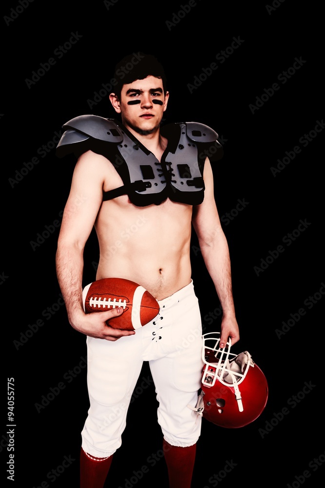 Composite image of american football player holding ball and helmet