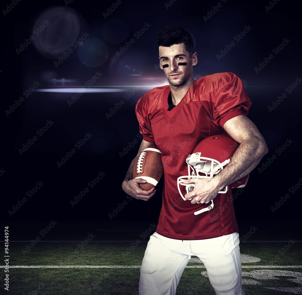 Composite image of rugby player holding ball and helmet