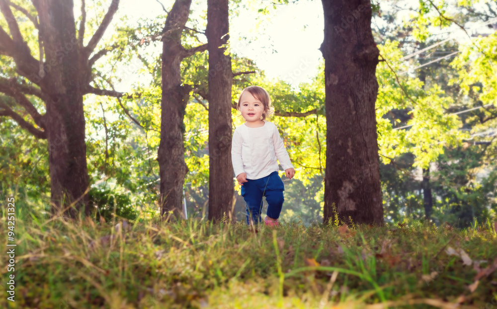 Happy toddler girl playing outside