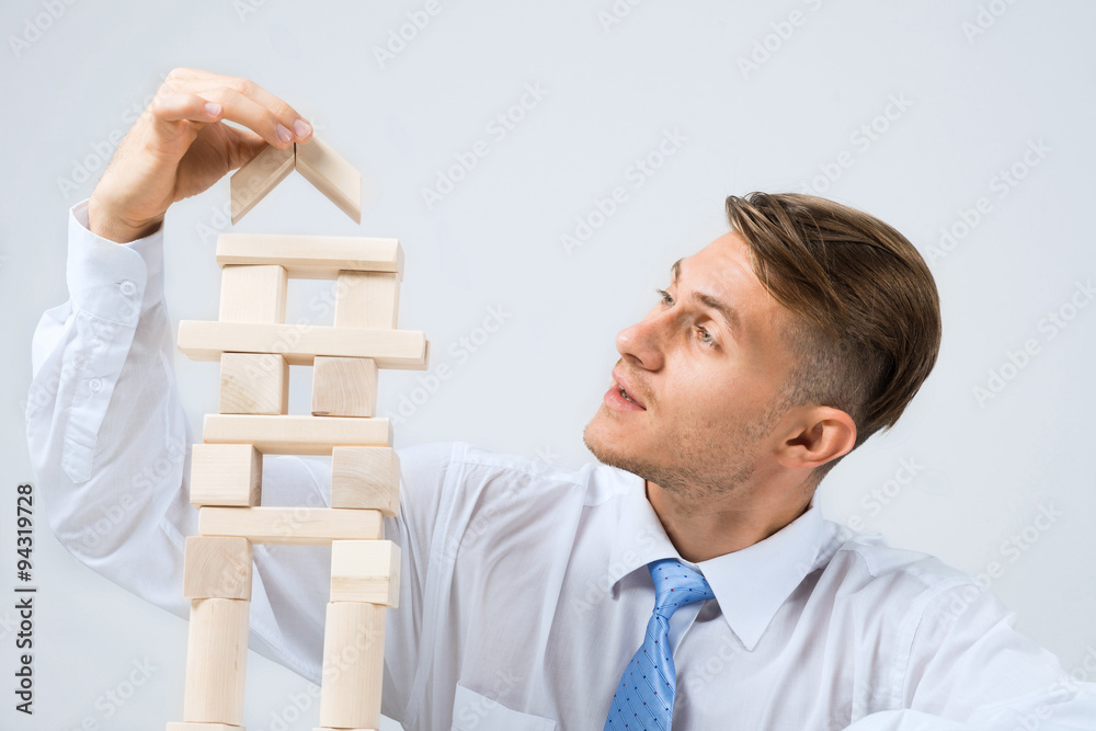 Businessman making tower