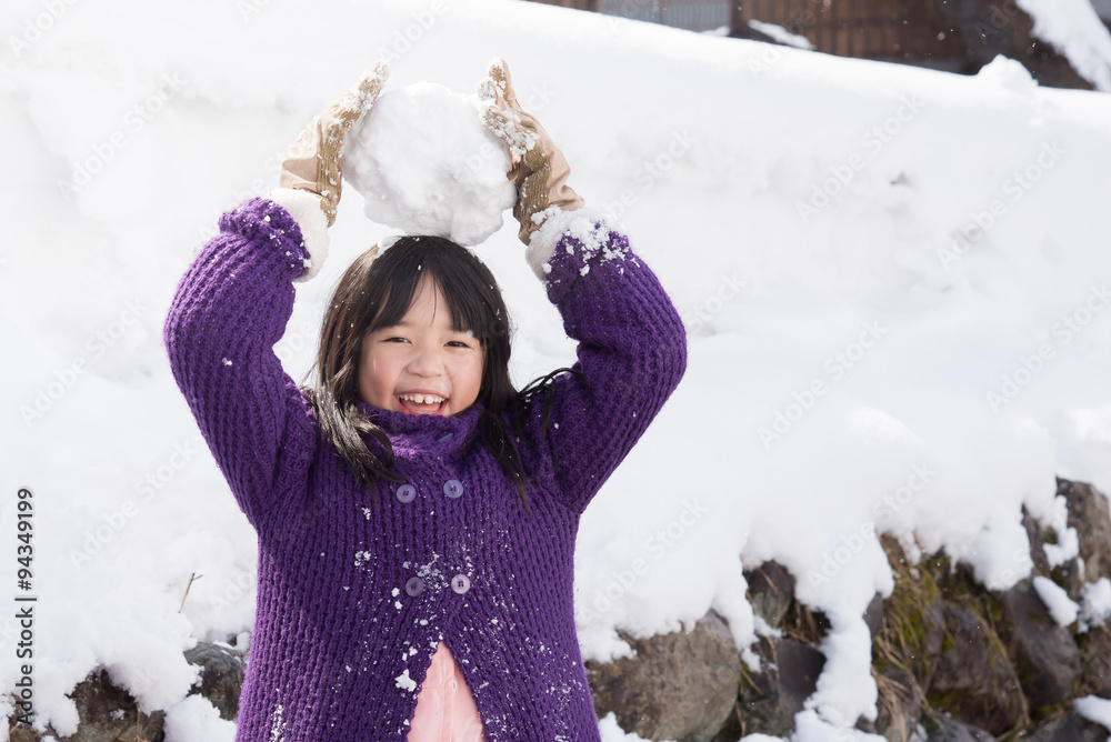 Cute asian girl smiling outdoors in snow