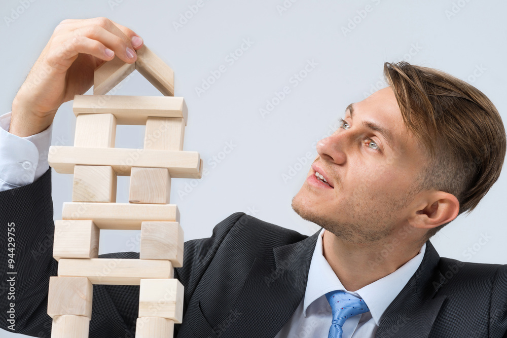 Businessman making tower