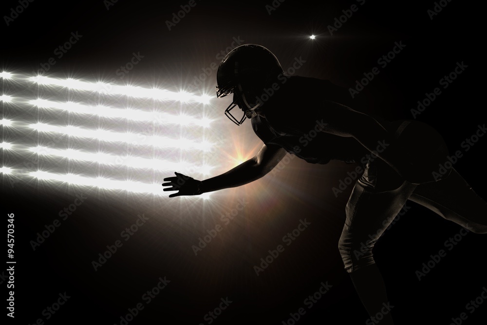 Composite image of silhouette american football player jumping