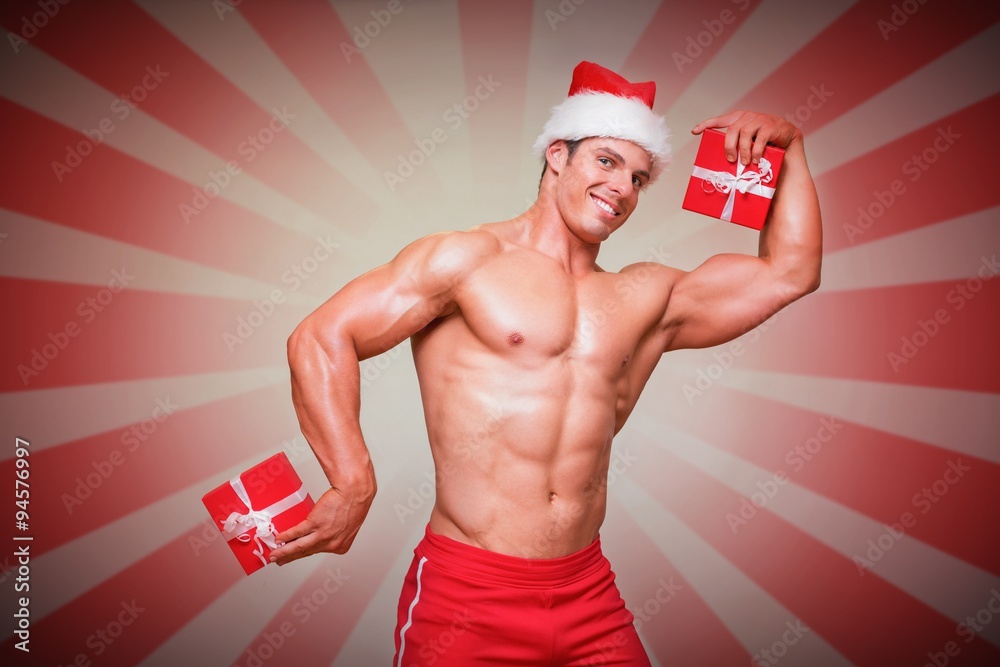 Composite image of shirtless man in santa hat holding gift