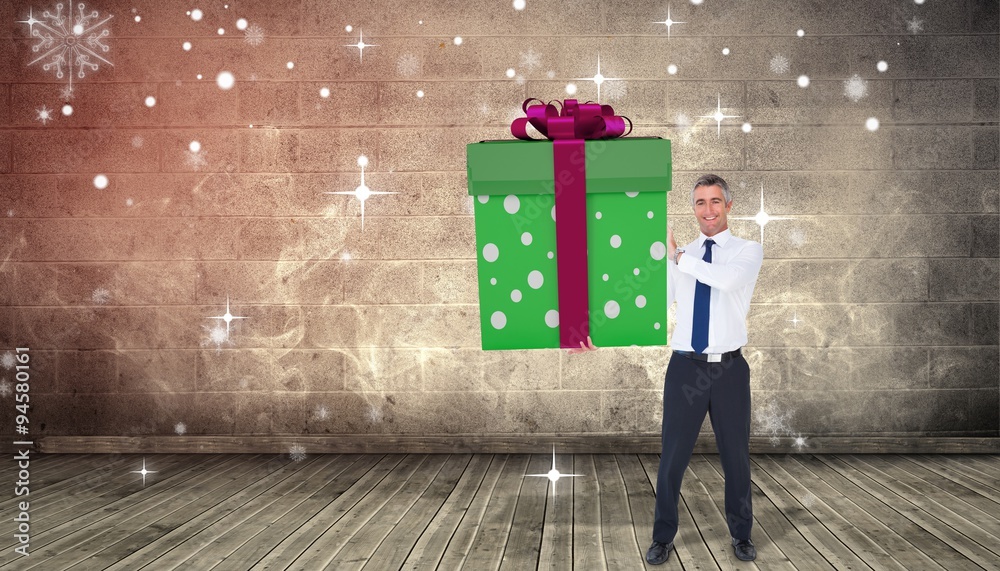 Composite image of stylish man with giant gift