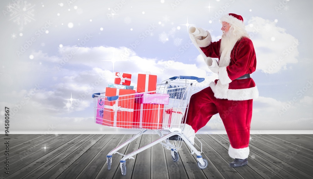 Composite image of santa delivering gifts from cart