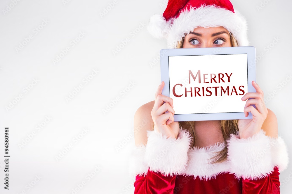 Composite image of pretty santa girl holding tablet