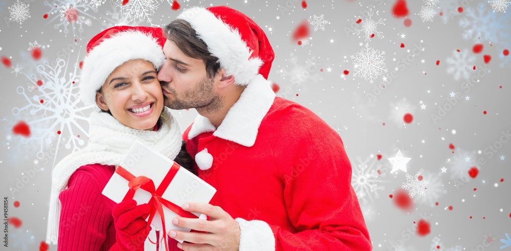 Composite image of festive young couple holding gift