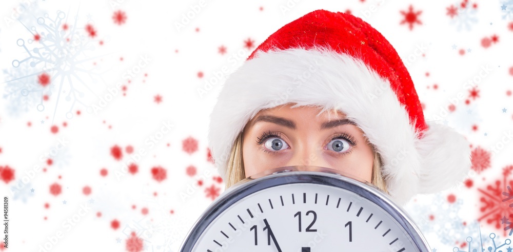 Composite image of festive blonde showing a clock