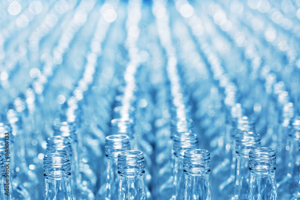 Number empty glass bottles on conveyor